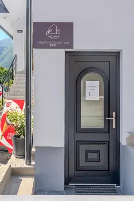 a black door with a sign on a building at Penzion Hosnar, apartma Time Out in Bovec