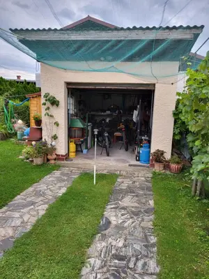 a garage with a blue awning on top of it at Peaceful 4-room house in Maribor - ski friendly in Maribor
