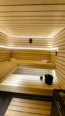 a sauna with a bowl sitting on a shelf at TEMPFER 2 Apartments & Rooms with new WELLNESS in Kranjska Gora