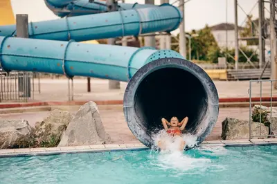 a person is coming out of a swimming pool at Apartments Čatež - Terme Čatež in Čatež ob Savi