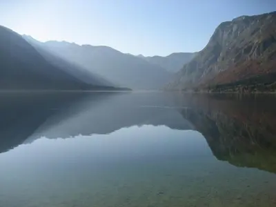 a large body of water with mountains in the background at Holiday Home- Mountain Lodge Gorjuše Pokljuka Bohinj in Koprivnik v Bohinju