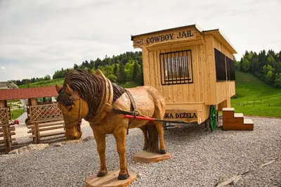 a statue of a horse standing in front of a building at Farm Stay Ana in Višnja Gora