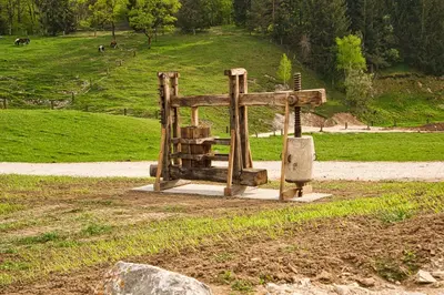 a wooden structure in the middle of a field at Farm Stay Ana in Višnja Gora