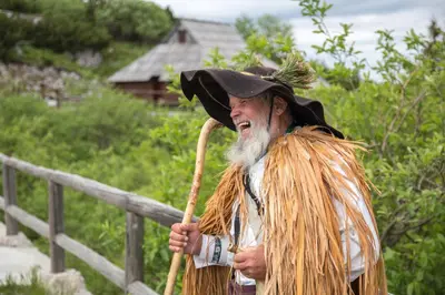 a man in a witch hat holding a broom at Koča Zlatorog - Velika planina in Stahovica