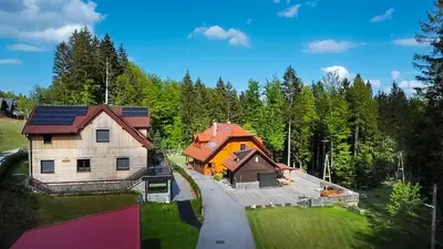an aerial view of a house with solar panels on it at Cabin Storzek in Pohorje