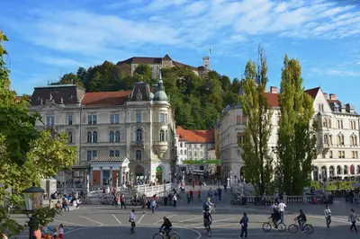 a group of people walking around a city with buildings at Apartment Gold in Ljubljana