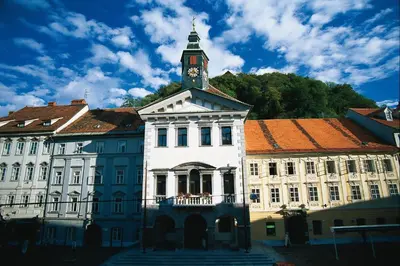 a building with a clock tower on top of it at Apartment Gold in Ljubljana