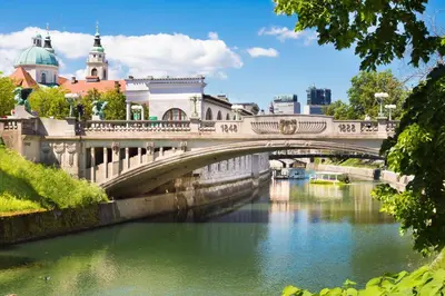 a bridge over a river in a city at Apartment Gold in Ljubljana