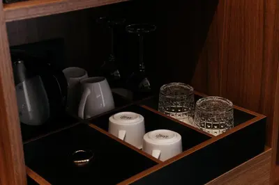 a cupboard with a row of candles and bottles at Boutique Hotel Dobrna - Terme Dobrna in Dobrna