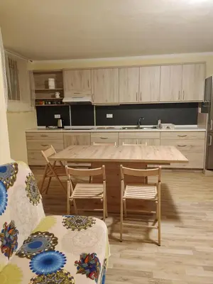 a kitchen with a large wooden table and chairs at Apartmaji Maki in Bled
