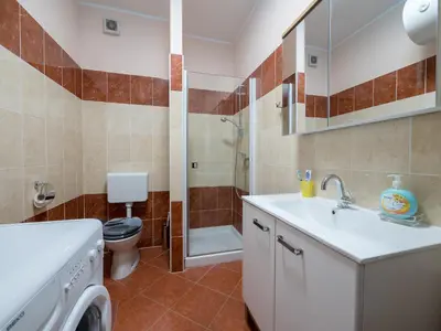 a bathroom with a sink and a toilet and a shower at Vila Bovec Sunrise apartment with balcony in Bovec