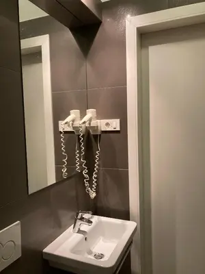 a bathroom with a sink and a mirror at Twix rooms in Ljubljana