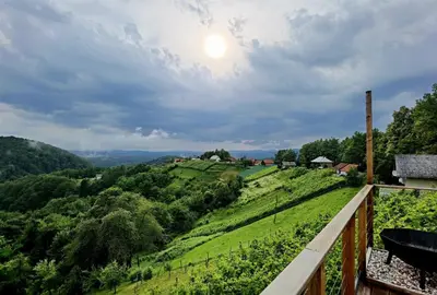 a view of a valley from the balcony of a farmhouse at Vineyard Cottage Sončni grič in Trebnje