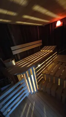 a row of wooden benches in a room at Treehouse Toplak in Ruše