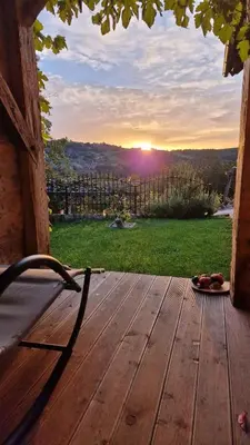 a wooden deck with a view of the sunset at Holiday home in Dvor Kranjska Krain 42901 in Dvor