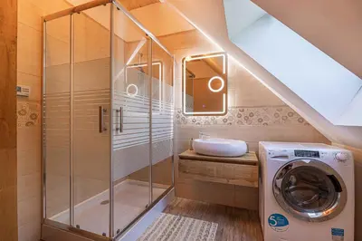 a bathroom with a washing machine and a sink at Holiday home in Otocec Kranjska Krain 42907 in Otočec