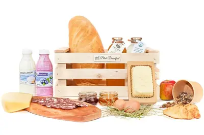 a crate filled with different types of bread and food at Lavender Lodge Bled in Bled