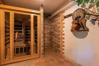a walk in wine cellar with a glass door and a brick wall at Holiday home in Novo Mesto - Dolenjska Bela krajina Unter- Weißkrain 35158 in Novo Mesto
