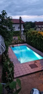 a large blue swimming pool with a brick walkway around it at APARTMAN MURKO S-1 in Brest