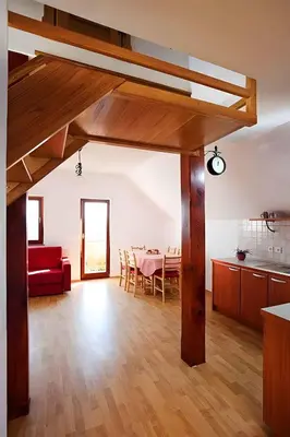 a living room with a red couch and a table at Holiday home in Otocec Kranjska Krain 26062 in Otočec