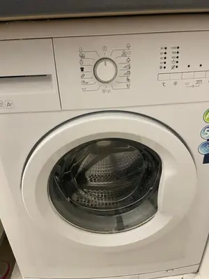 a white washing machine with the door open at ICE APARTMENT in Ljubljana