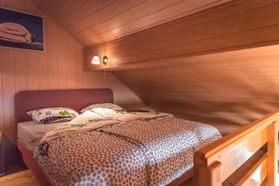 a bedroom with a bed in a wooden room at Holiday home in Mirna Kranjska Krain 36158 in Mirna