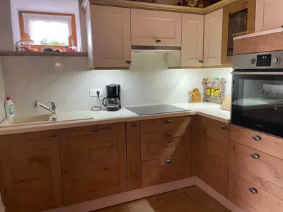 a kitchen with wooden cabinets and a sink at Holiday home in Drganja sela Kranjska Krain 42002 in Drganja Sela