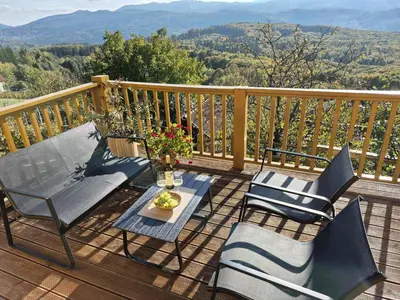 a deck with chairs and a table with a view at Holiday home in Drganja sela Kranjska Krain 42002 in Drganja Sela