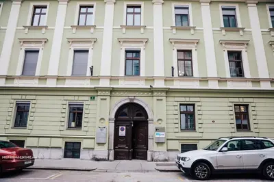 a white car parked in front of a building at Apartment Center - Kersnikova in Ljubljana