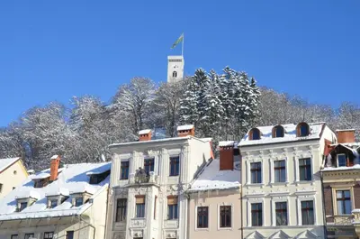 a white building with snow on top of it at i Design 9 in Ljubljana